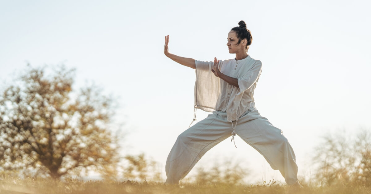 Woman practising tai chi outdoors